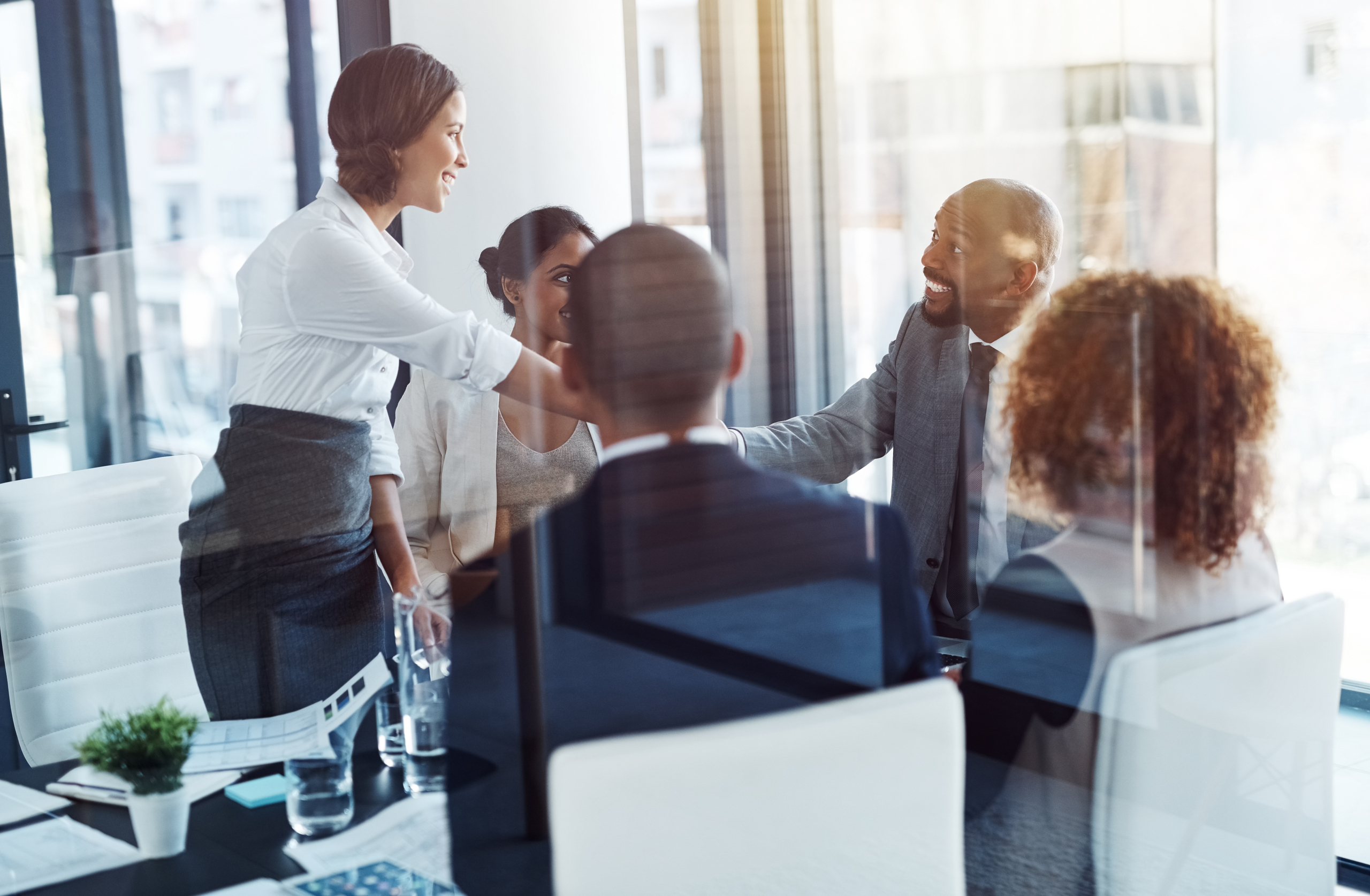 Business people, meeting and shaking hands with corporate group, respect or agreement with contract. Executive men, woman and welcome with ceo, onboarding or hiring for collaboration at finance job